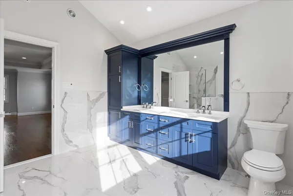 a bathroom with a granite countertop sink mirror and a bathtub