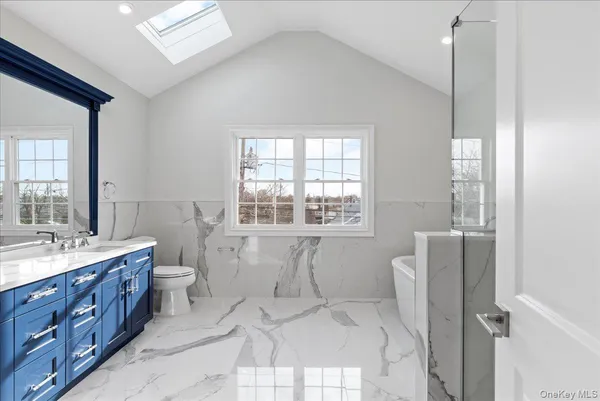 a white bath tub sitting next to a bathroom
