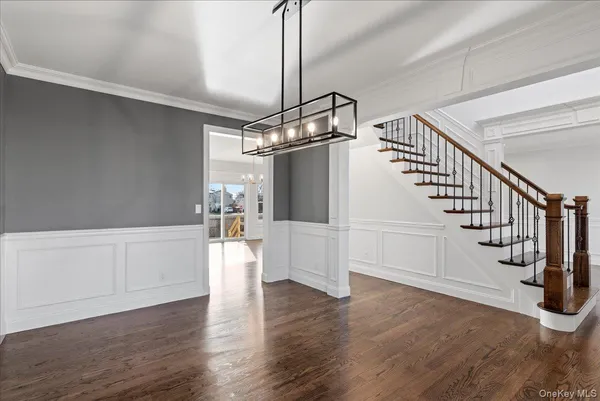 a view of entryway and hall with wooden floor