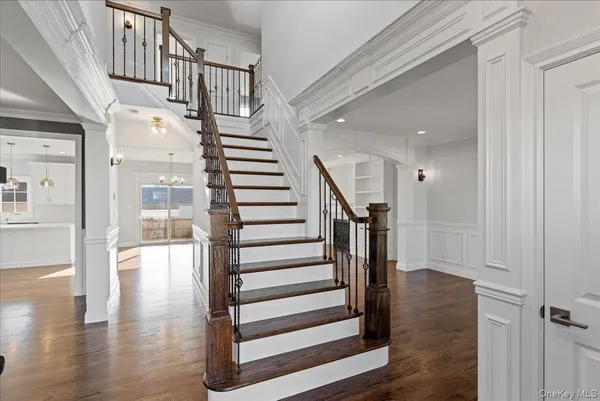 a view of entryway and hall with wooden floor