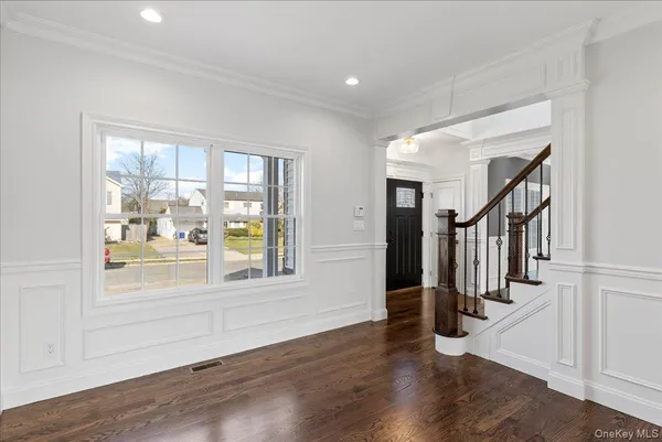 a view of an entryway with wooden floor