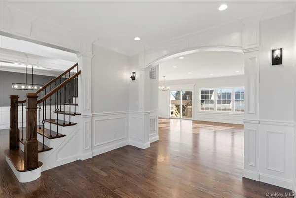 a view of entryway and hall with wooden floor