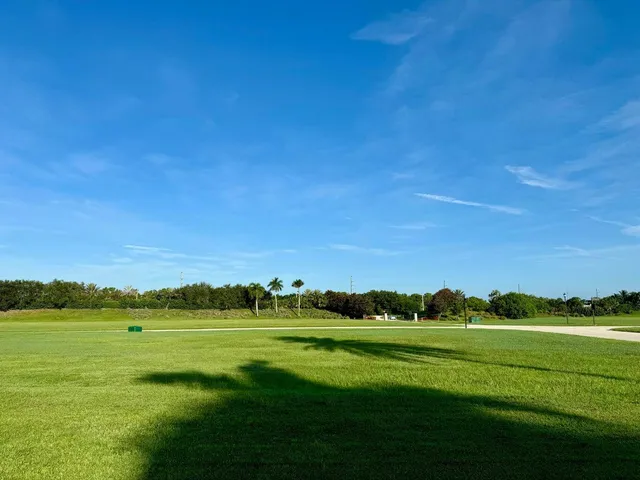 a view of a field with an ocean