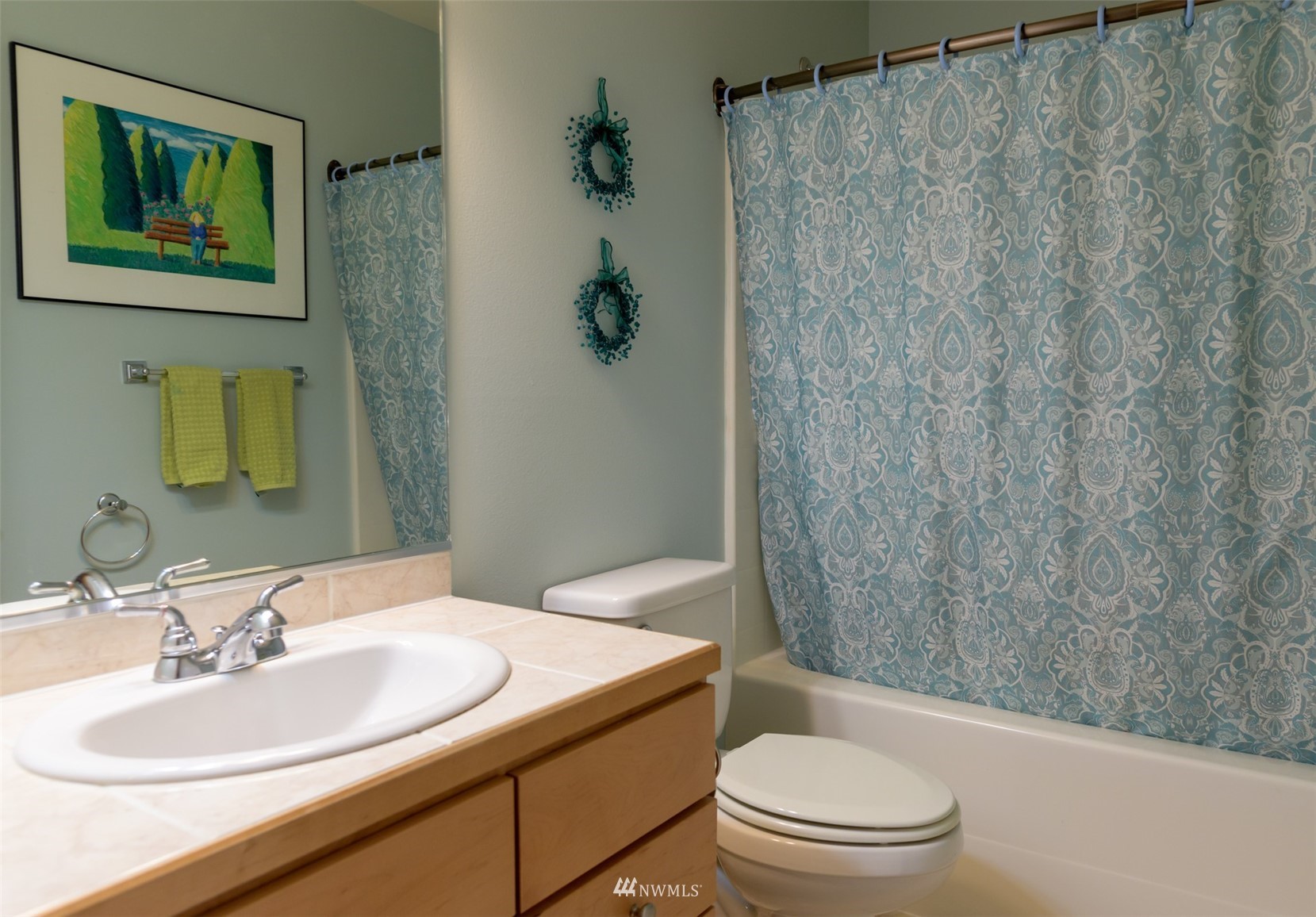 713 Sylvan Way Bremerton, WA 98310 - Photo 18 of 32 a bathroom with a sink a toilet and shower curtain