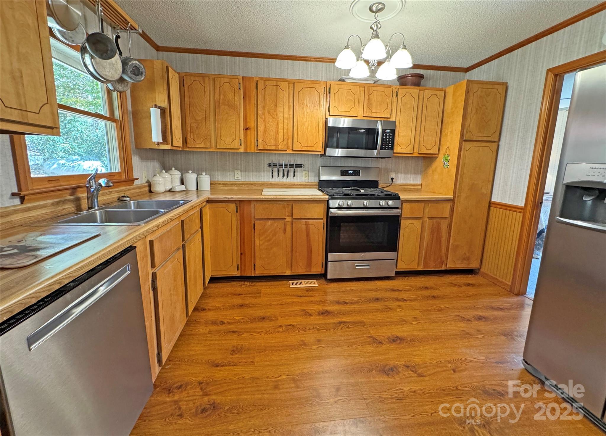 1622 Meadow Fork Road Hot Springs, NC 28743 - Photo 4 of 31 a kitchen with stainless steel appliances granite countertop a sink dishwasher stove top oven and refrigerator