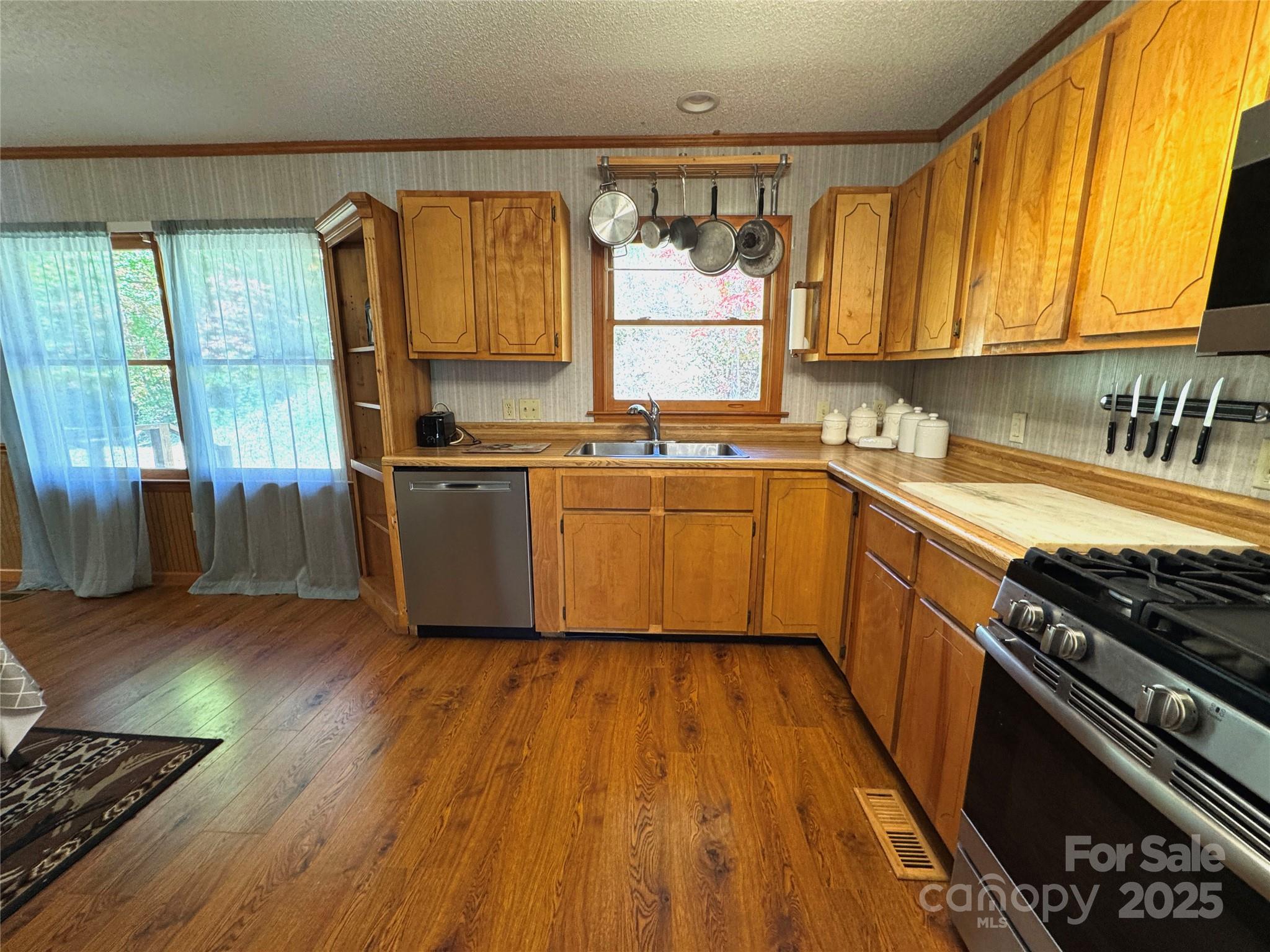1622 Meadow Fork Road Hot Springs, NC 28743 - Photo 7 of 31 a kitchen with wooden floors and stainless steel appliances