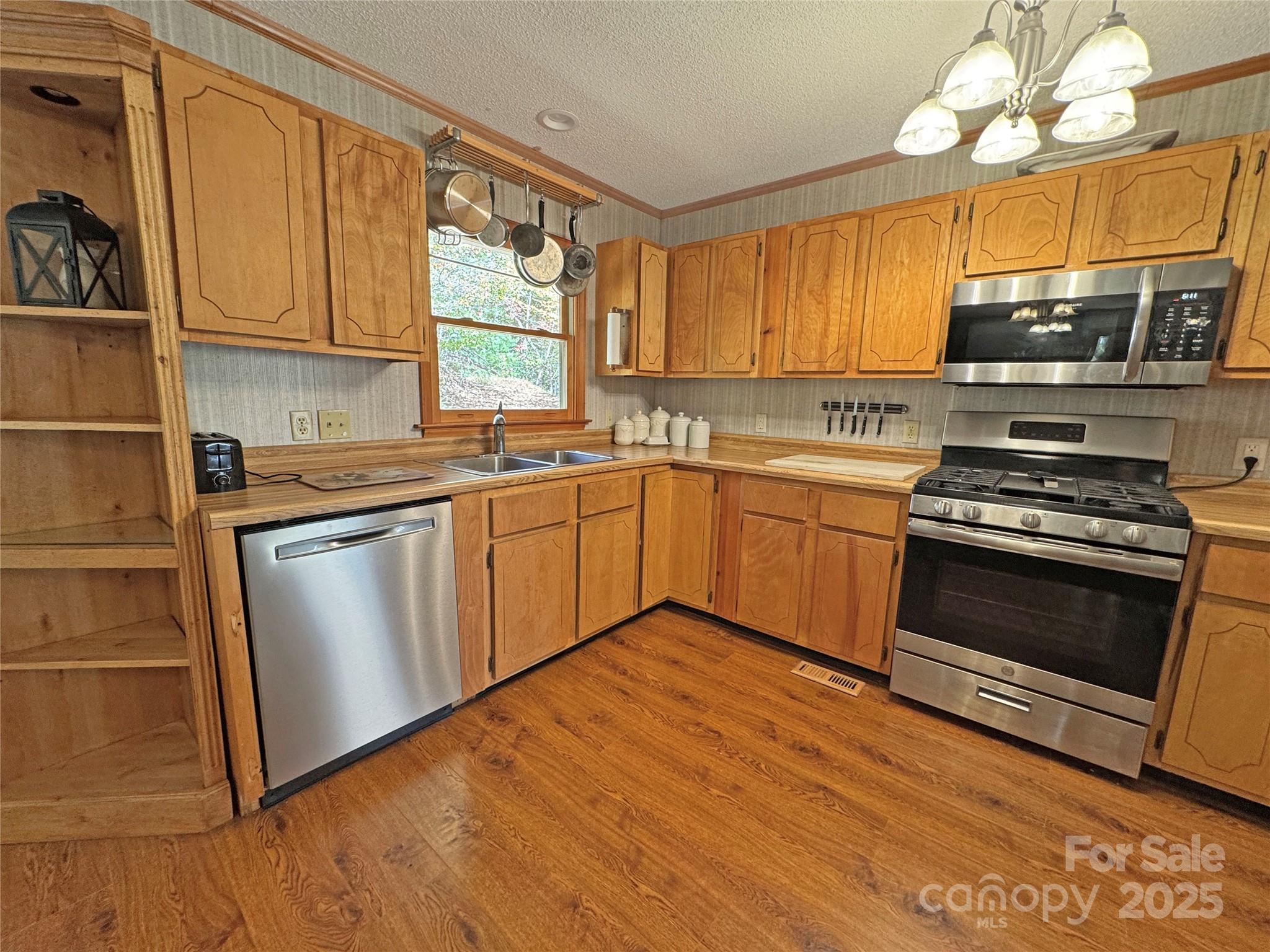 1622 Meadow Fork Road Hot Springs, NC 28743 - Photo 8 of 31 a kitchen with stainless steel appliances granite countertop a stove a sink and a microwave