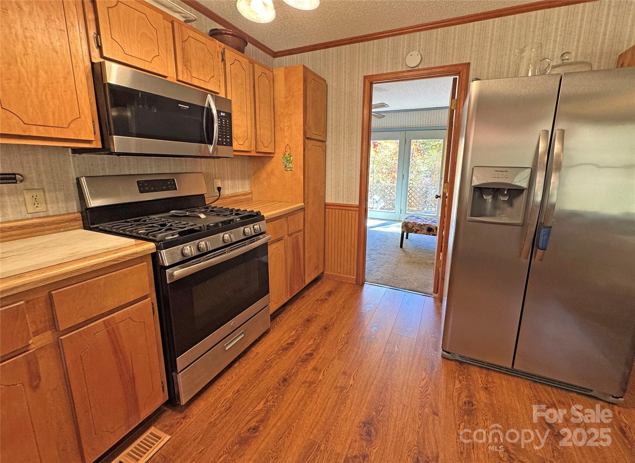1622 Meadow Fork Road Hot Springs, NC 28743 - Photo 10 of 31 a kitchen with a refrigerator stove and wooden floor