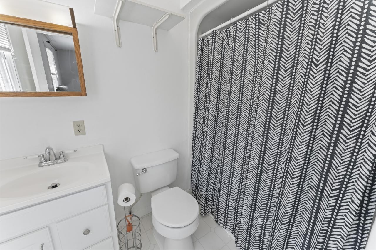 102 Aldrin Street Tullahoma, TN 37388 - Photo 14 of 21 a white toilet sitting next to a bathroom sink