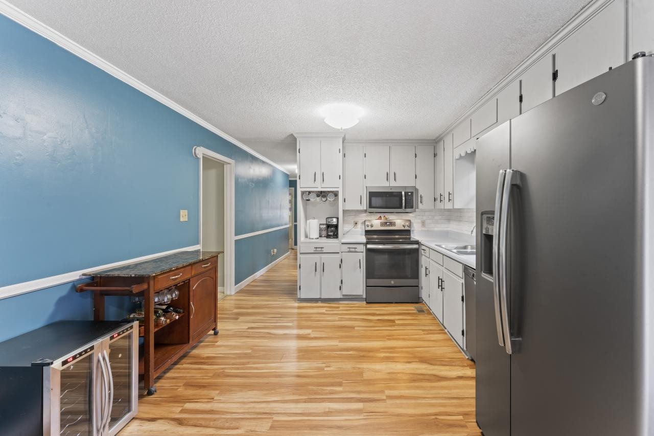 102 Aldrin Street Tullahoma, TN 37388 - Photo 3 of 21 a kitchen with stainless steel appliances a refrigerator and a stove