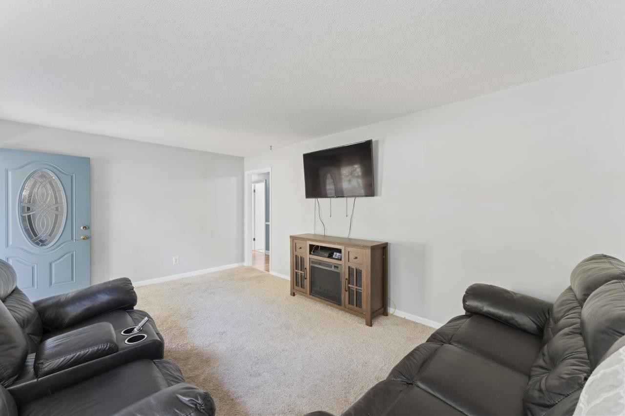 102 Aldrin Street Tullahoma, TN 37388 - Photo 6 of 21 a living room with furniture a flat screen tv and a fireplace