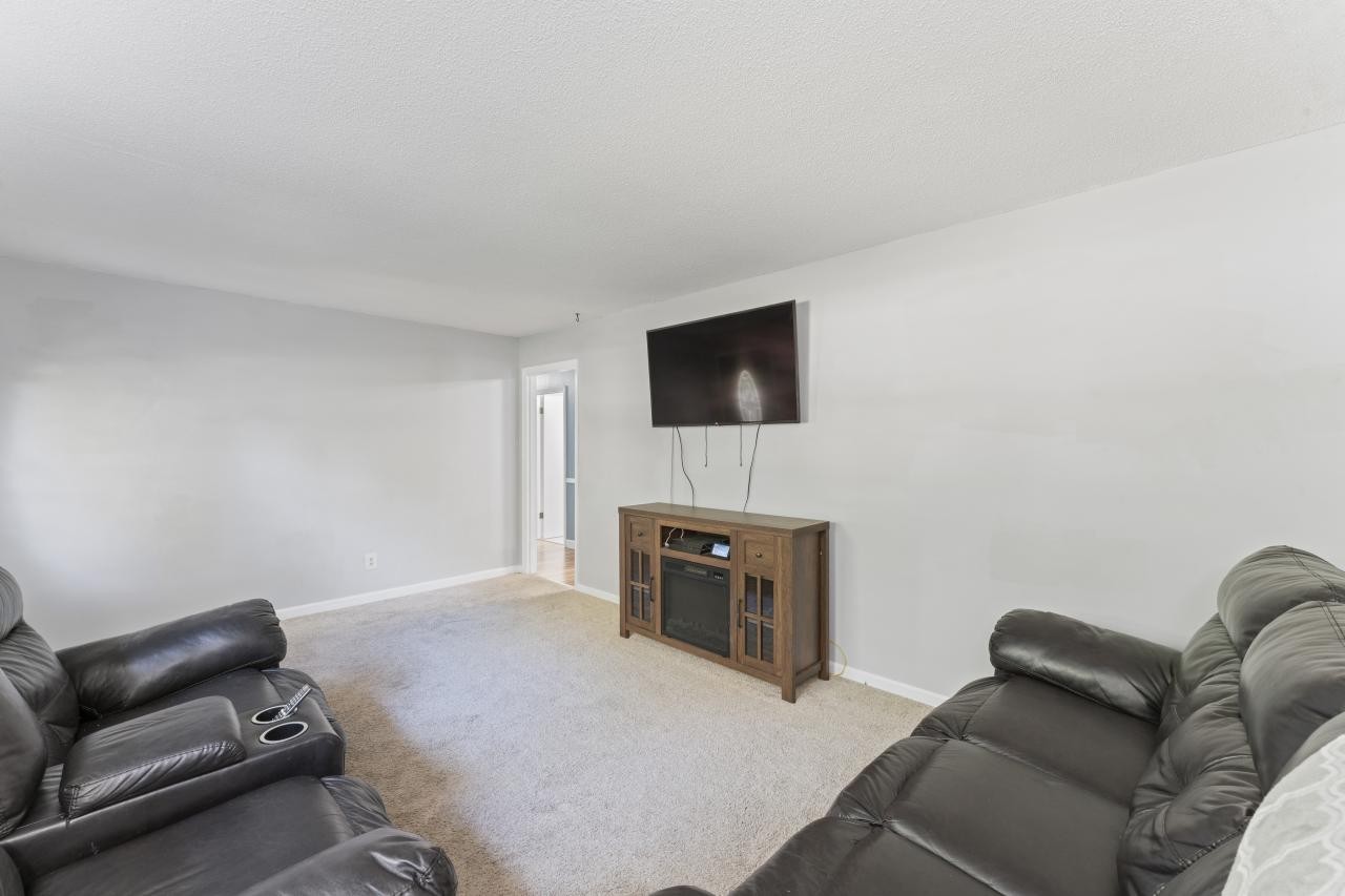 102 Aldrin Street Tullahoma, TN 37388 - Photo 7 of 21 a living room with furniture and a flat screen tv