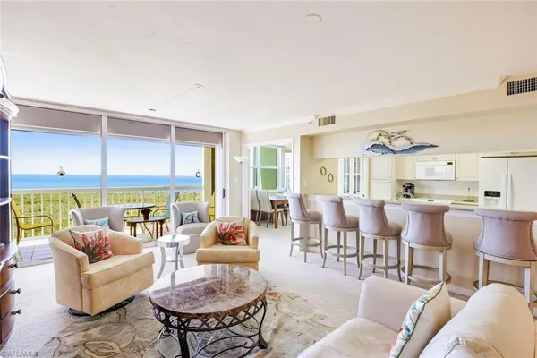 a living room with lots of furniture and a large window