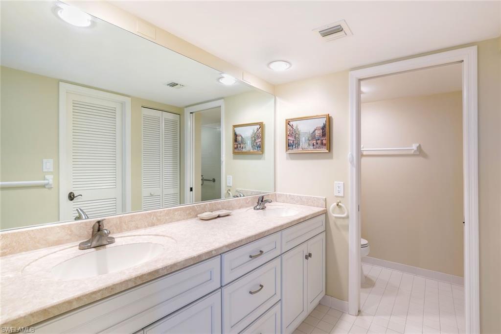 6573 Marissa Loop, Unit 1902 Naples, FL 34108 - Photo 10 of 21 a bathroom with a granite countertop sink mirror and double
