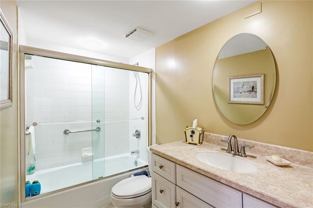 6573 Marissa Loop, Unit 1902 Naples, FL 34108 - Photo 12 of 21 a bathroom with a granite countertop sink toilet and shower