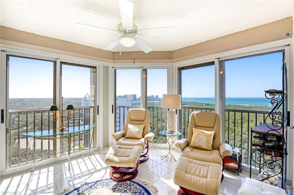 6573 Marissa Loop, Unit 1902 Naples, FL 34108 - Photo 13 of 21 a living room with furniture and floor to ceiling windows
