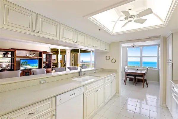a spacious en suite bathroom with a granite countertop sink and a mirror