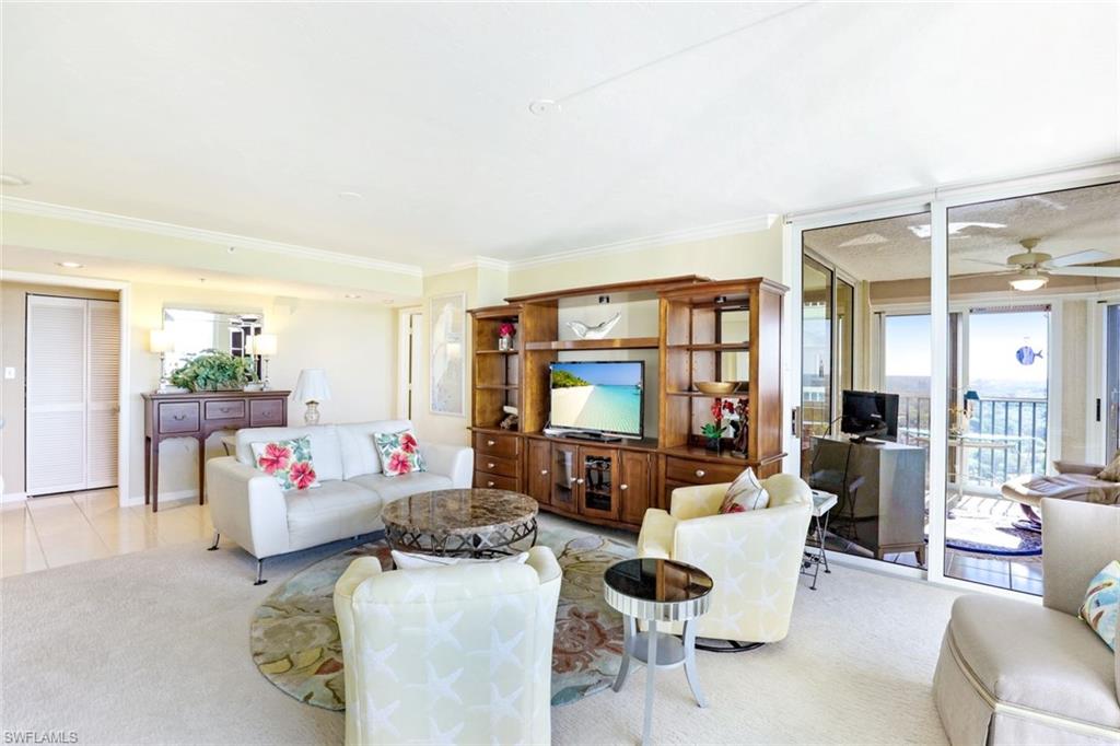 6573 Marissa Loop, Unit 1902 Naples, FL 34108 - Photo 7 of 21 a living room with furniture and a flat screen tv