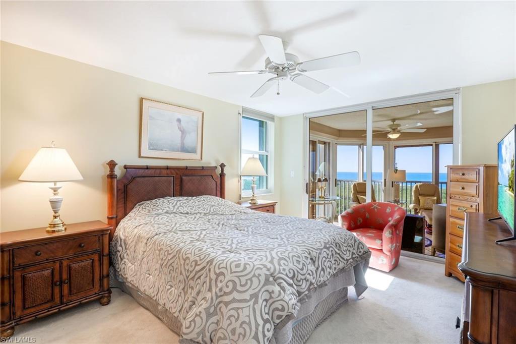 6573 Marissa Loop, Unit 1902 Naples, FL 34108 - Photo 8 of 21 a bedroom with a bed and wooden floor