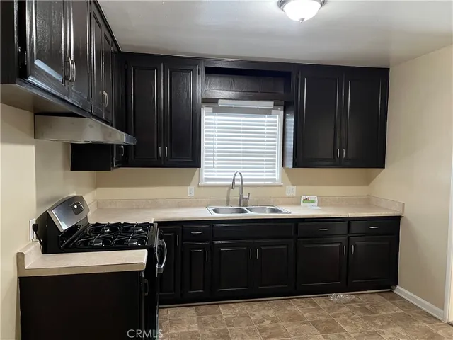 a kitchen with stainless steel appliances wooden cabinets and a sink