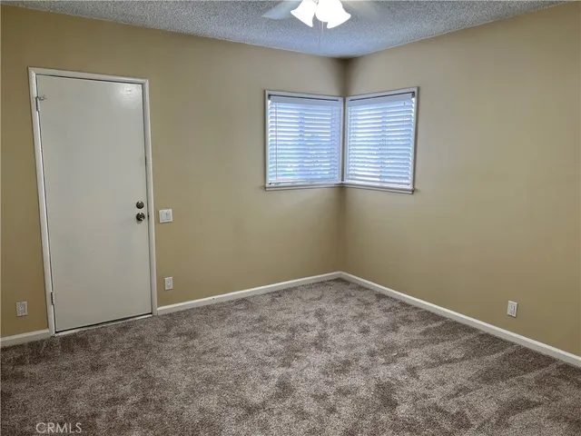 an empty room with closet and a bathroom