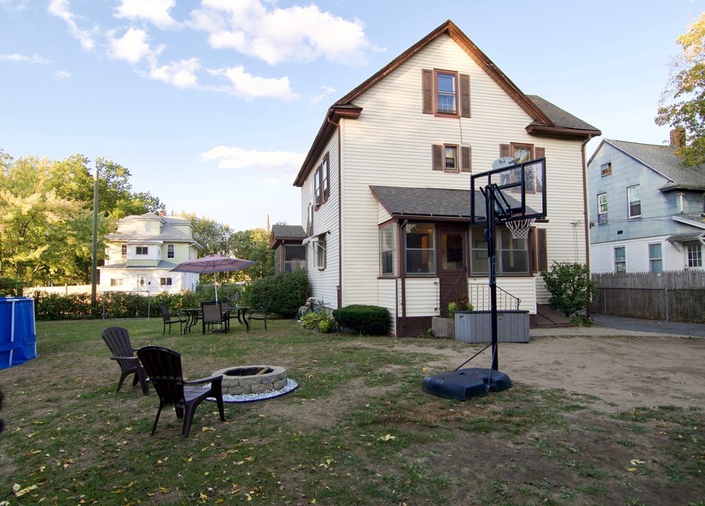 244 Allen Street Springfield, MA 01108 - Photo 3 of 42 a front view of a house with garden and trees