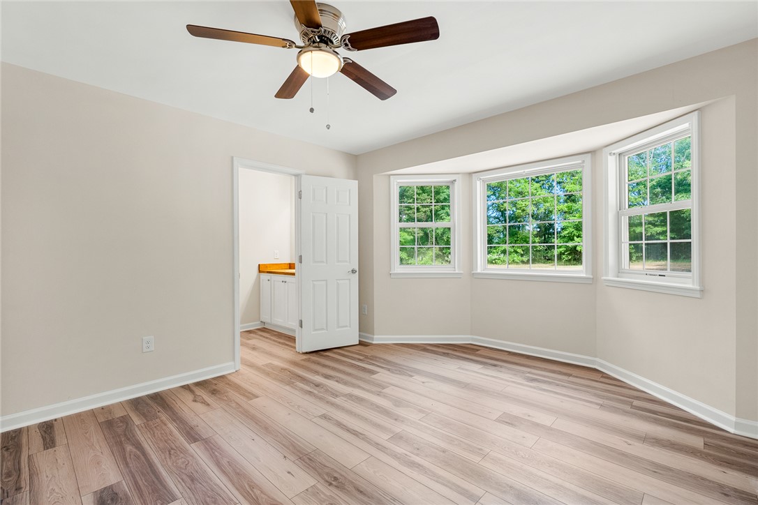 131 Lockaby Road Pelzer, SC 29669 - Photo 24 of 50 This bright room features a bay window overlooking lush greenery and durable wood flooring.