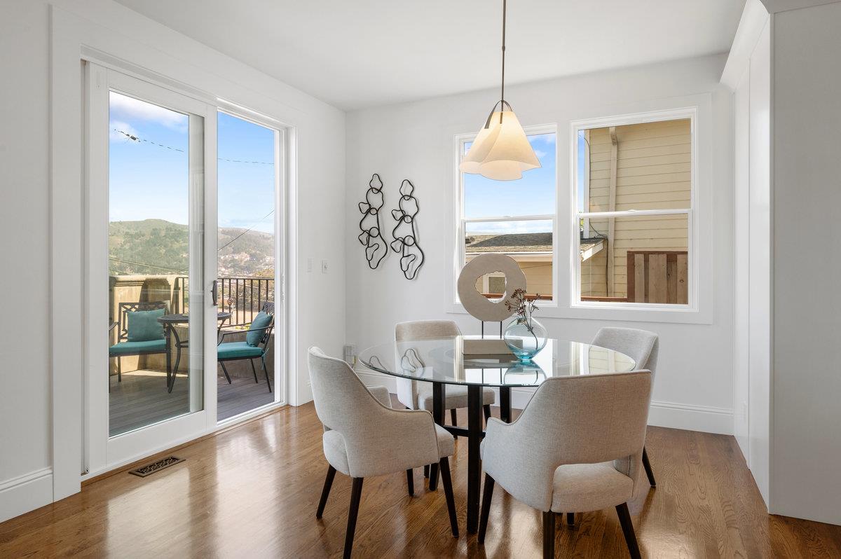 240 Stanley Avenue Pacifica, CA 94044 - Photo 12 of 100 a dining room with furniture a chandelier and wooden floor