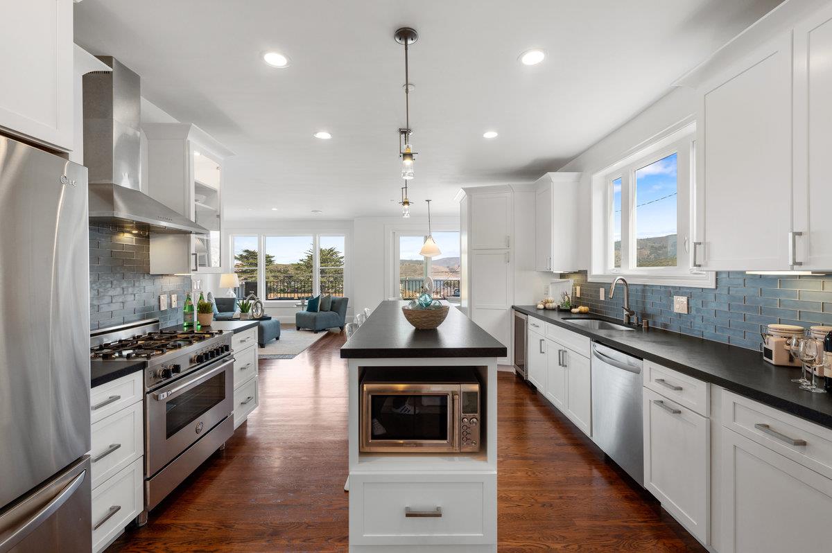 240 Stanley Avenue Pacifica, CA 94044 - Photo 16 of 100 a kitchen with granite countertop a stove and a wooden floor