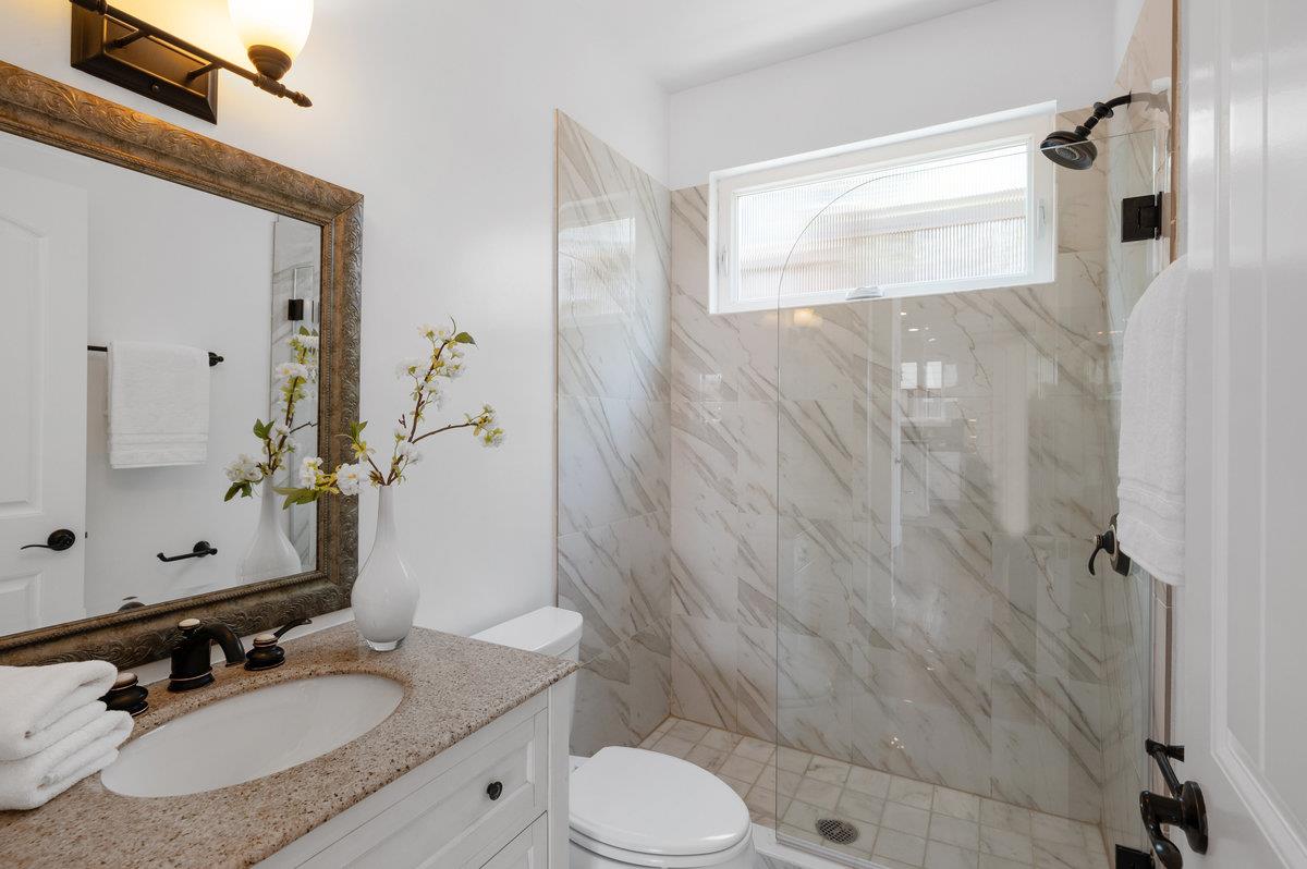 240 Stanley Avenue Pacifica, CA 94044 - Photo 59 of 100 a bathroom with a granite countertop sink toilet a mirror and shower