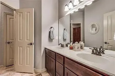 a bathroom with a double vanity sink and a mirror