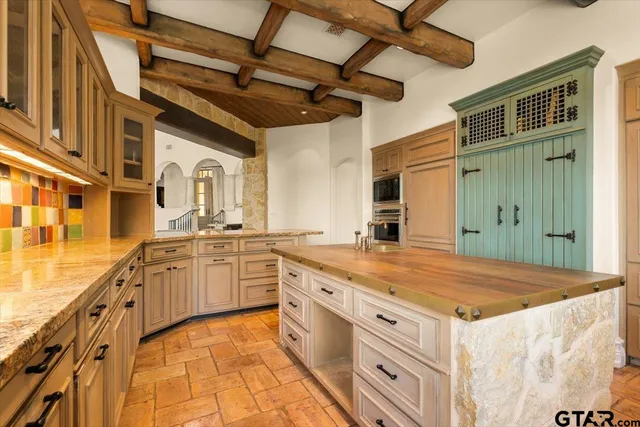 a spacious bathroom with a granite countertop sink and a mirror