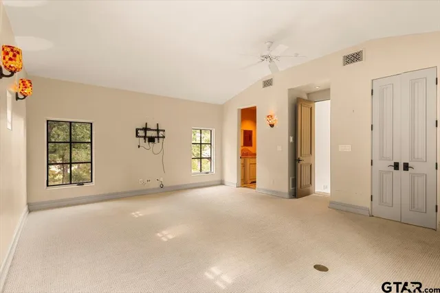 an empty room with windows and closet