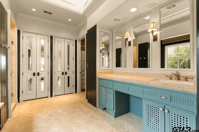 a bathroom with a double vanity sink and a mirror