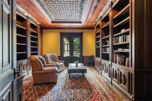 a living room with furniture and a book shelf