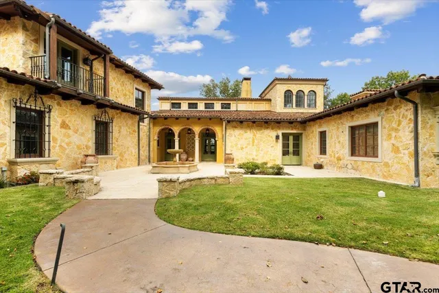 a front view of a house with swimming pool having outdoor seating