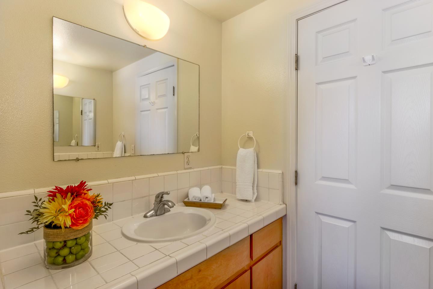 124 Sycamore Street Santa Cruz, CA 95060 - Photo 18 of 40 a bathroom with a granite countertop sink and a mirror