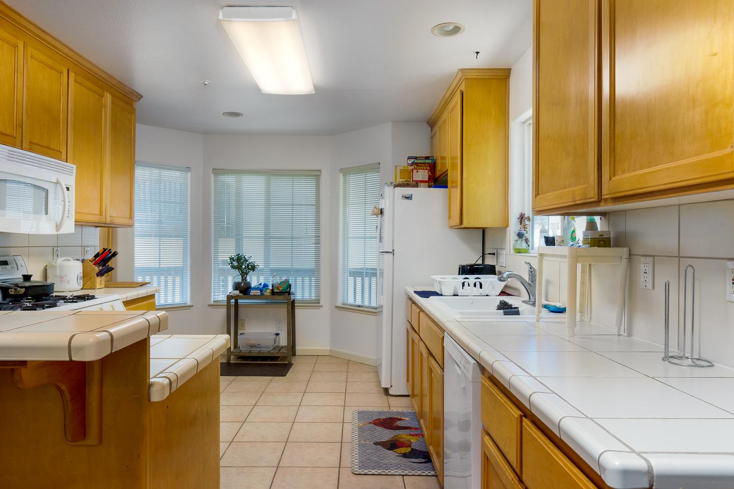 124 Sycamore Street Santa Cruz, CA 95060 - Photo 26 of 40 a kitchen with a sink a stove and cabinets