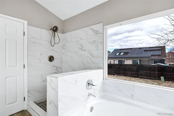 a bathroom with a bathtub and shower