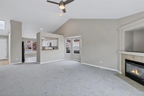 a view of a livingroom with an empty space and a fireplace