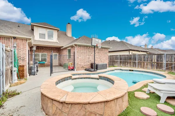 a house view with a swimming pool and outdoor seating