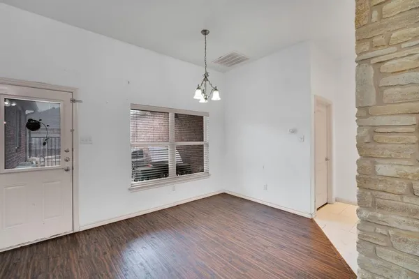 a view of a room wooden floor and window