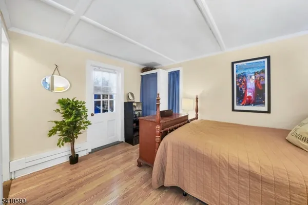 a bedroom with bed and a potted plant