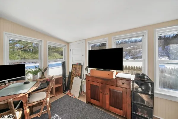 a view of a livingroom with workspace and a window