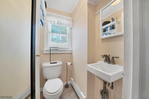 a bathroom with a toilet a sink and a window