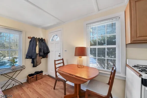 a view of a workspace with furniture and a window