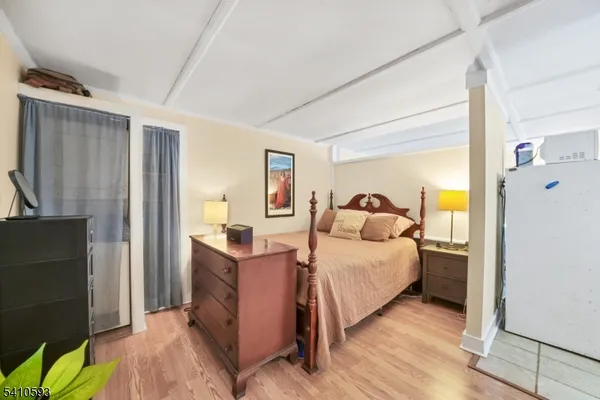 a bedroom with a bed and a mirror