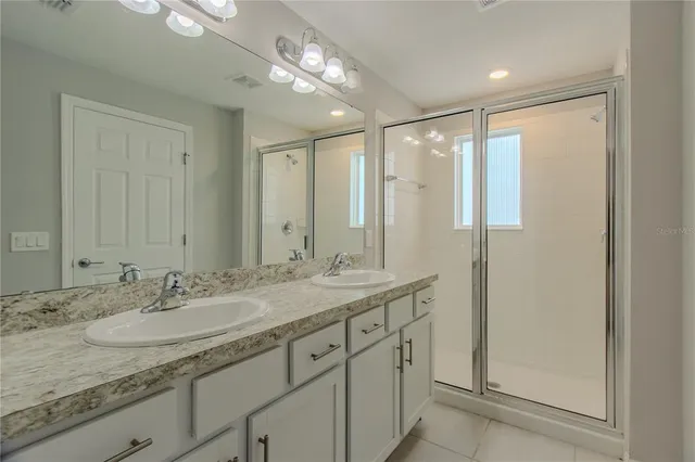a bathroom with a granite countertop sink mirror and double
