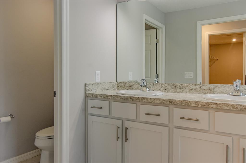 3470 Beau Road Kissimmee, FL 34746 - Photo 23 of 40 a bathroom with a granite countertop sink and a toilet