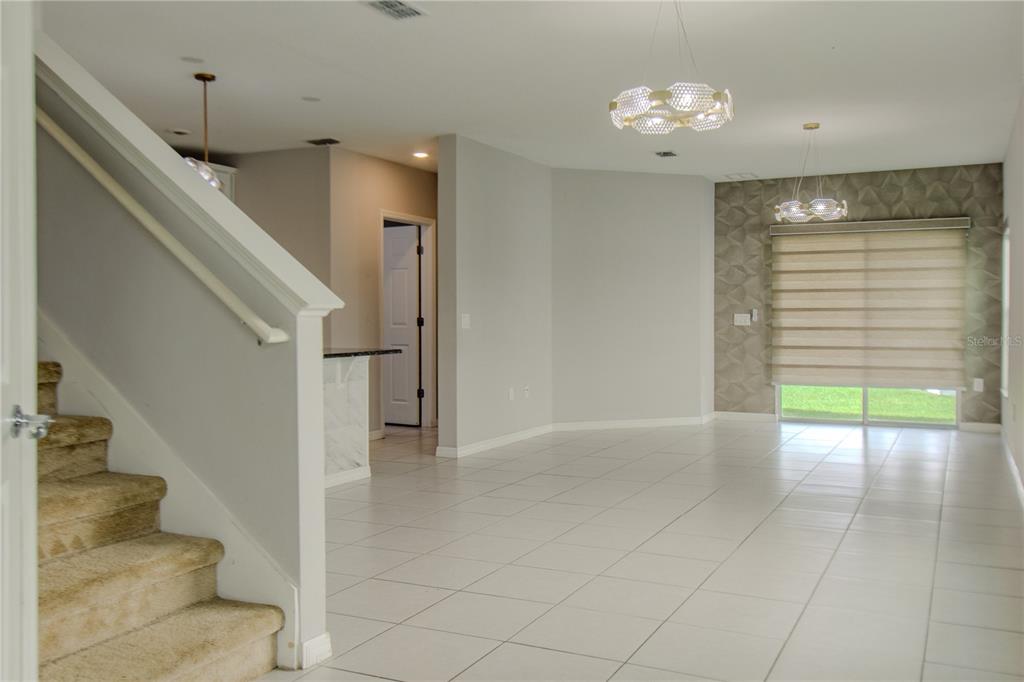 3470 Beau Road Kissimmee, FL 34746 - Photo 24 of 40 a view of an entryway with wooden floor and a living room